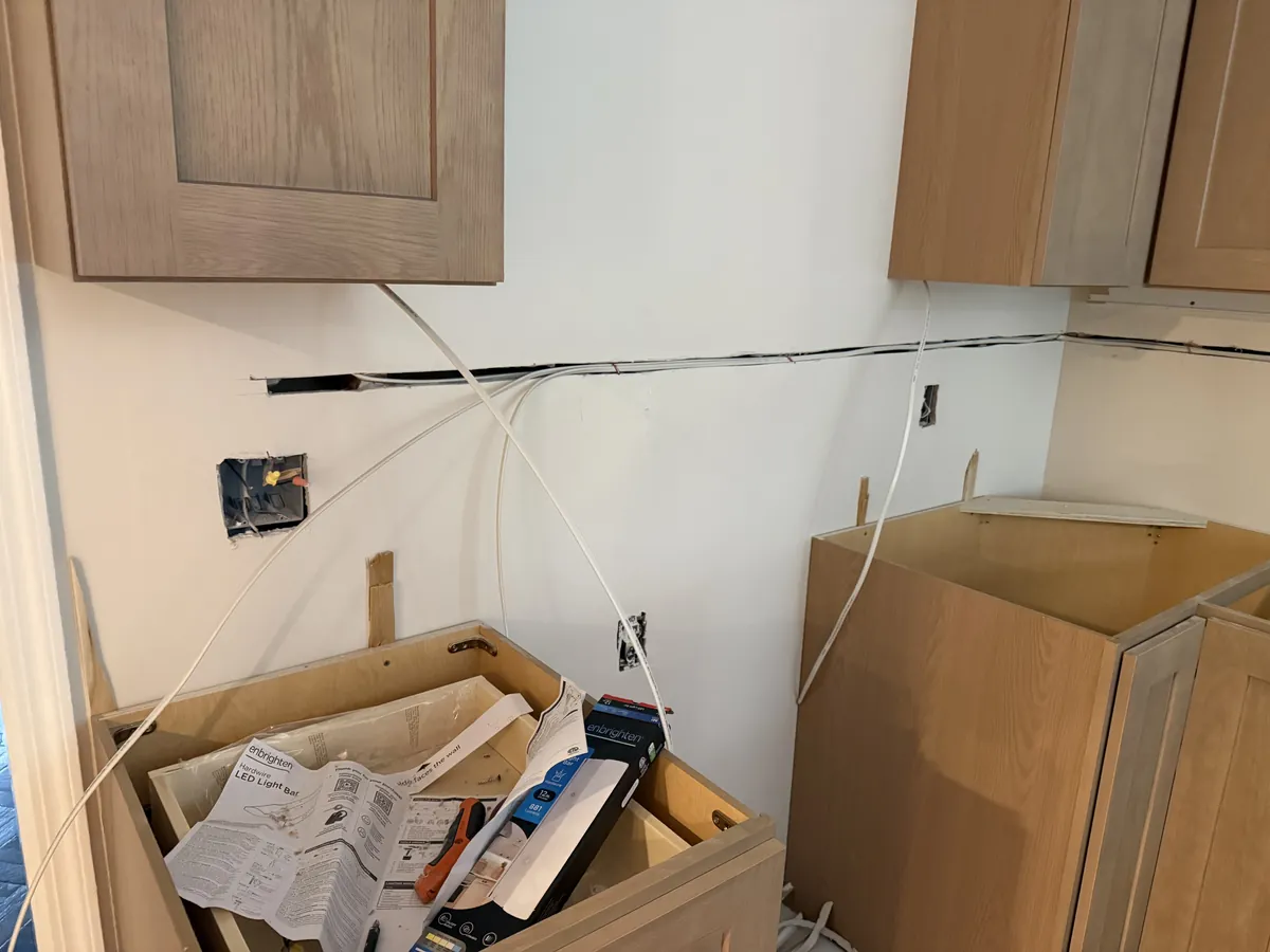 Electrician wiring a kitchen during renovation